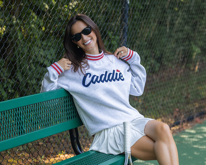 Lifestyle model wearing Women's Caddie Logo Mockneck Sweatshirt Pullover landscape photo