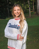 Lifestlye model portrait wearing Women's Caddie Logo Mockneck Sweatshirt Pullover 