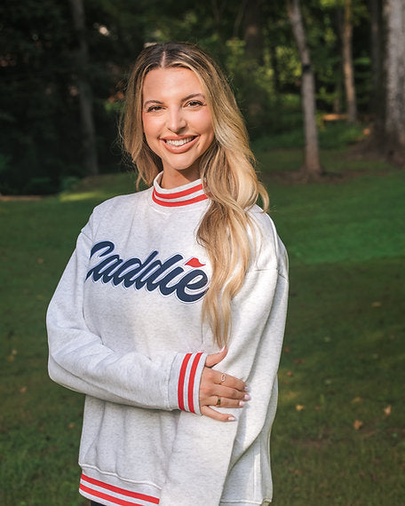 Lifestlye model portrait wearing Women's Caddie Logo Mockneck Sweatshirt Pullover 